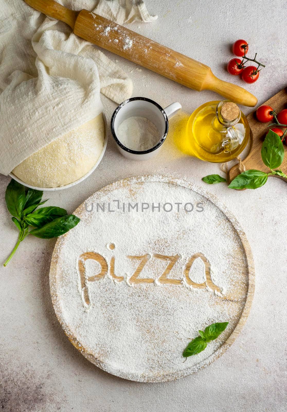 top view pizza dough with tomatoes word written flour. High resolution photo