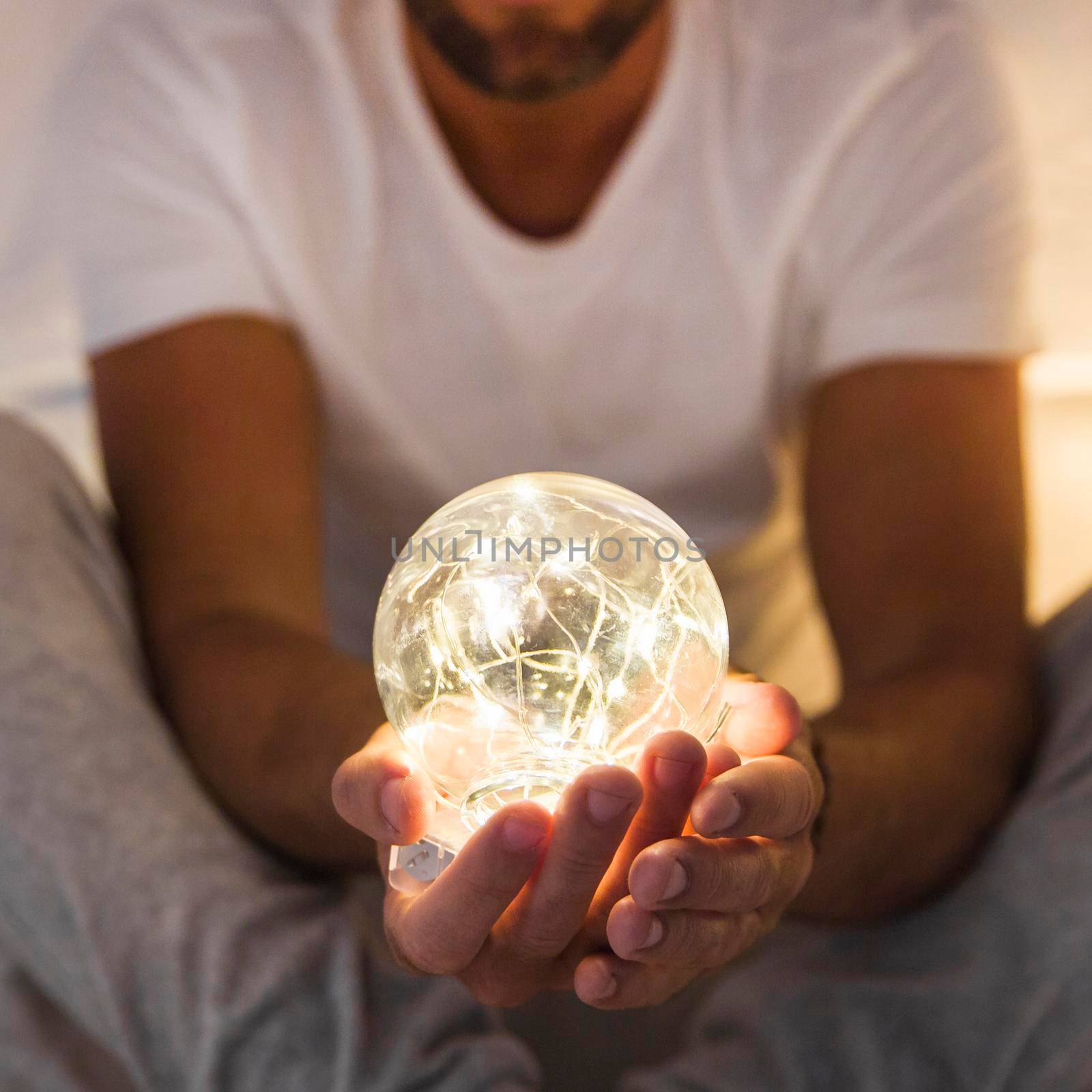 man holding glowing transparent sphere. High resolution photo