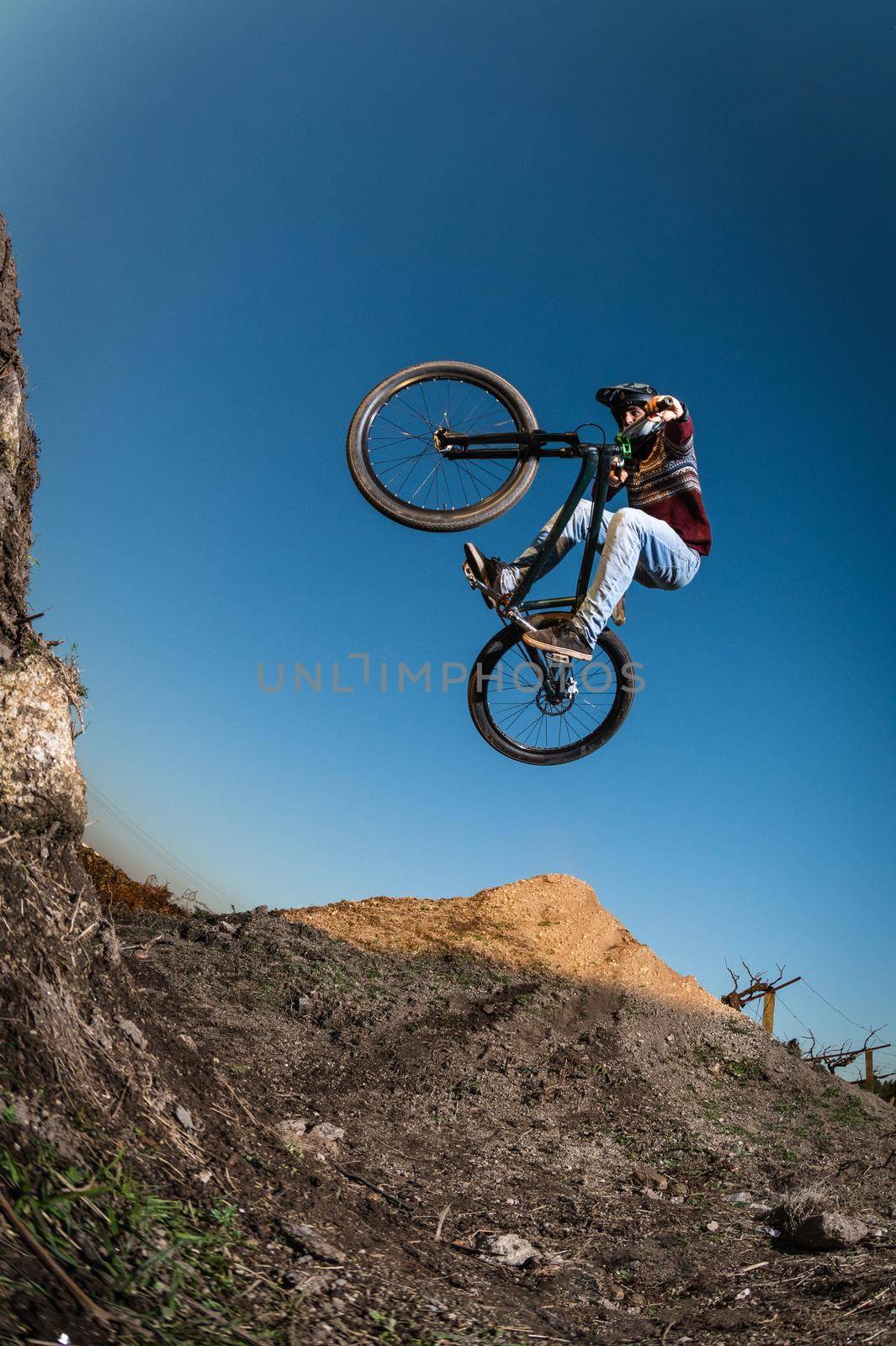 MTB Bike jump over a dirt trail on a dirt track.