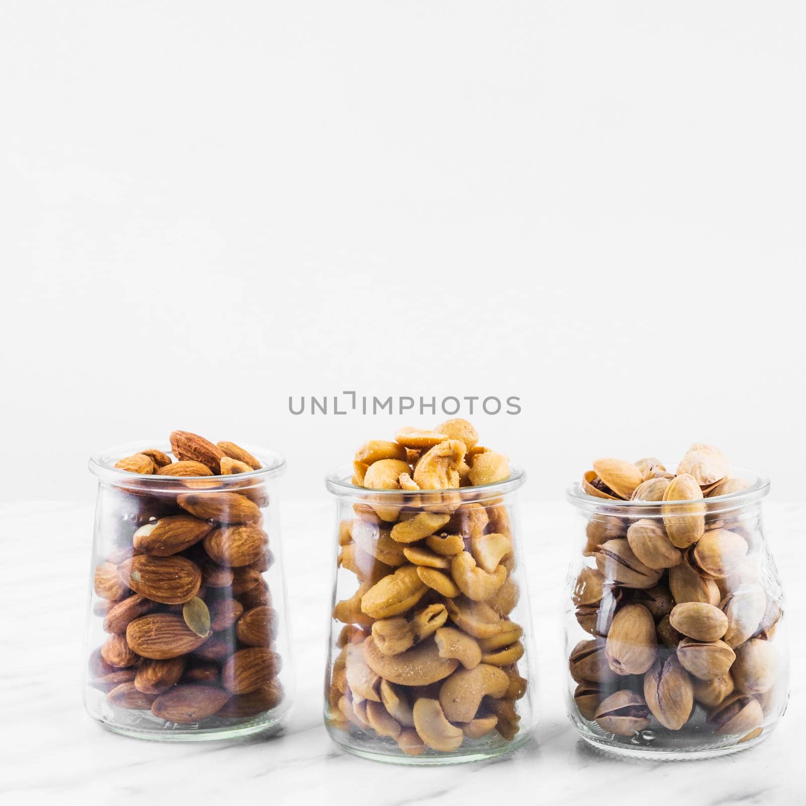 almonds cashewnuts pistachios marble backdrop. High resolution photo
