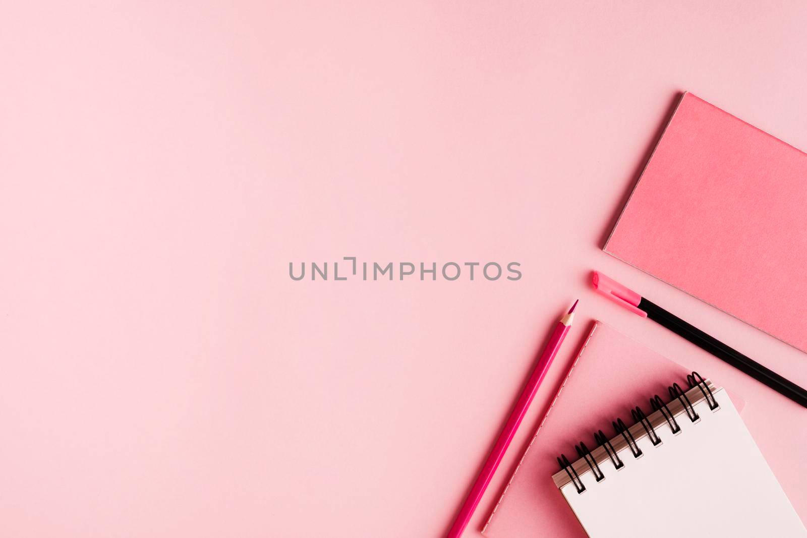 pink office supplies colored surface. High resolution photo