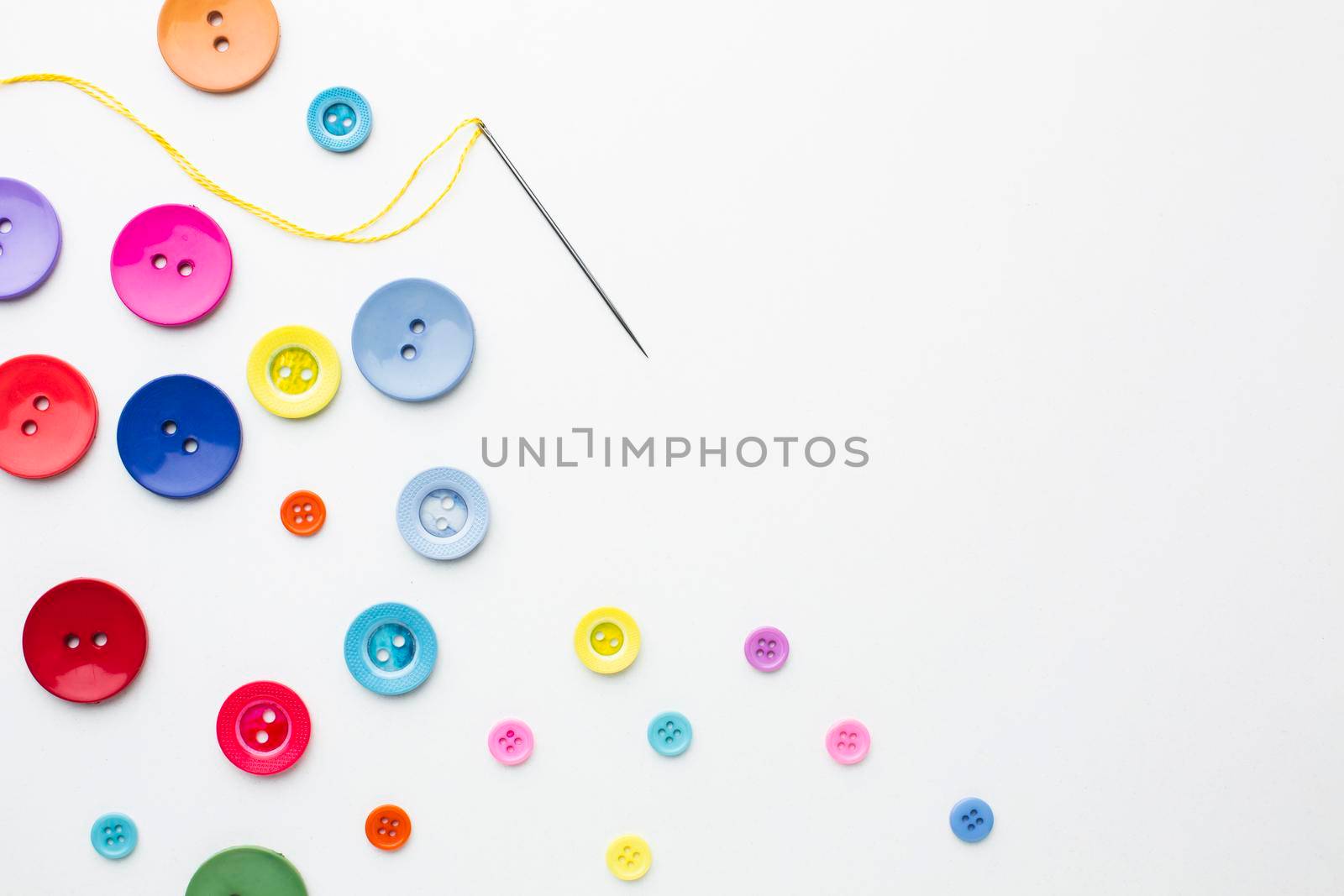 clothes colourful buttons with needle . High resolution photo