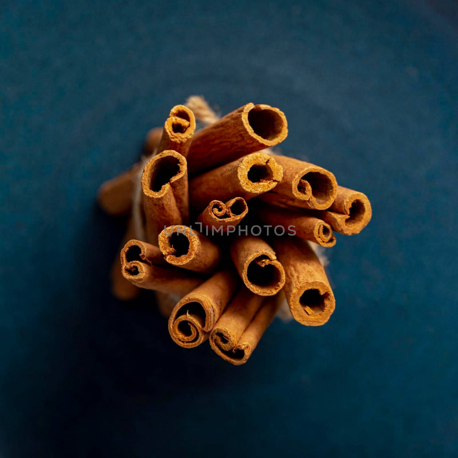bunch cinnamon sticks dark blue background. High resolution photo