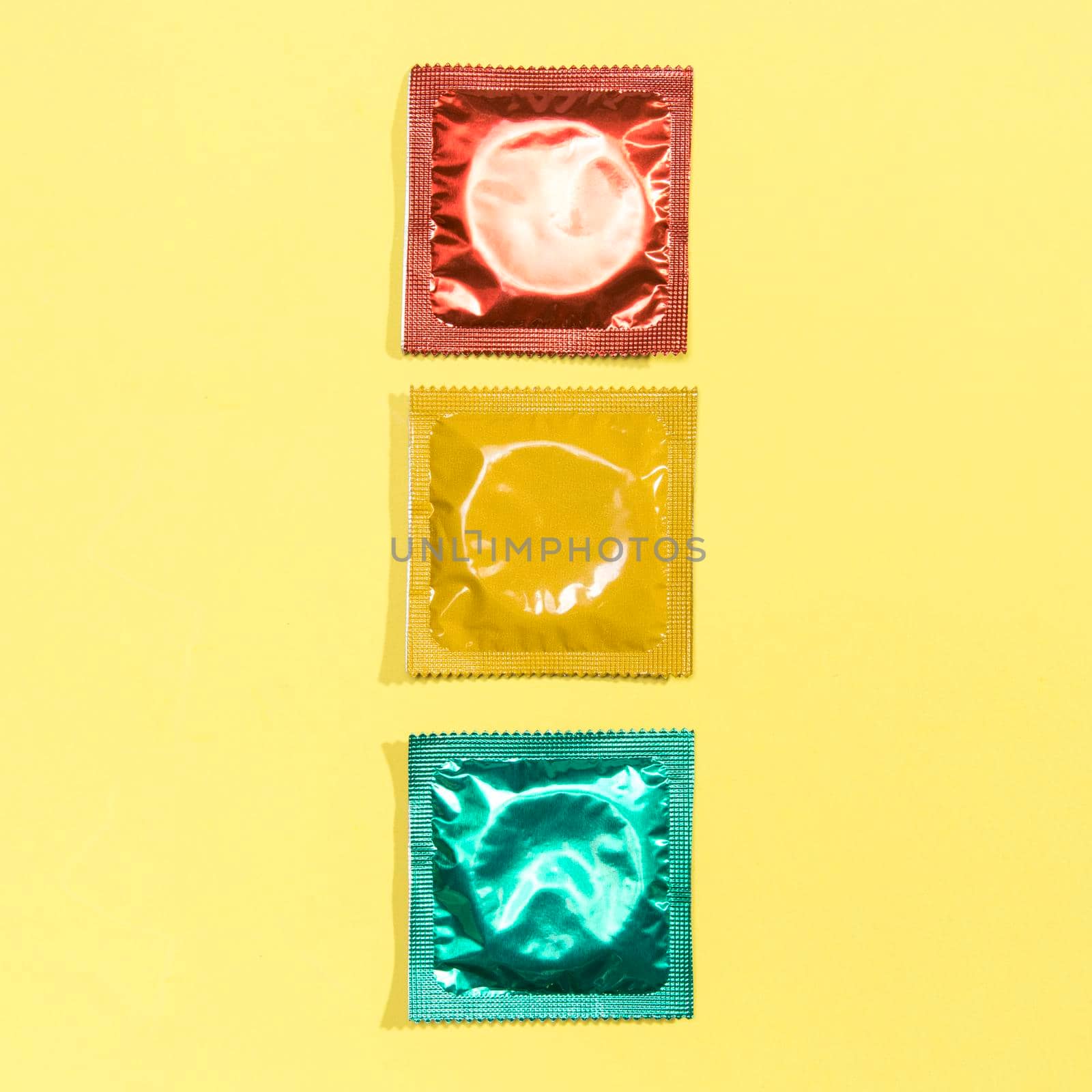 top view red yellow green condoms. High resolution photo