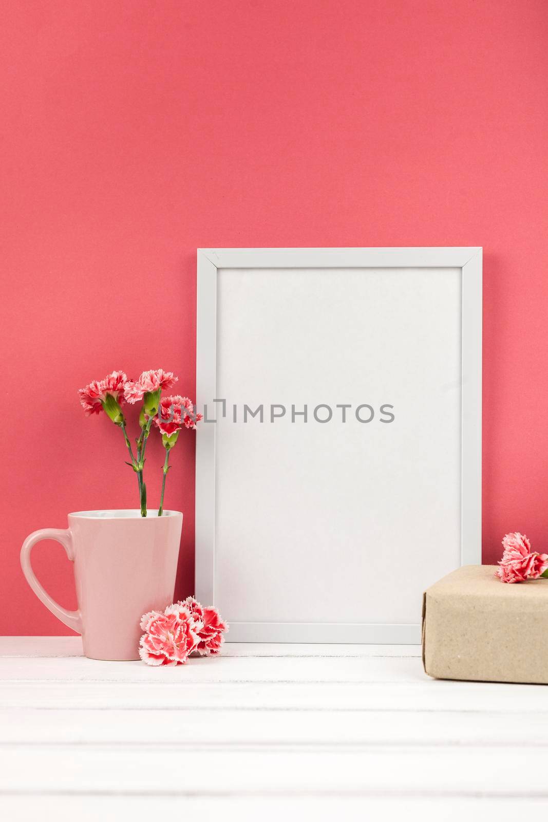 carnation flowers gift box cup white empty frame table. High resolution photo