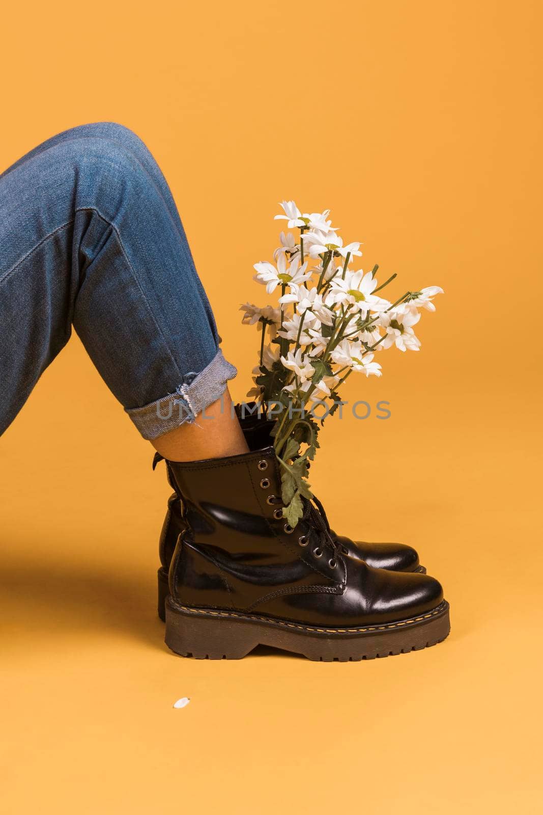 sitting female legs boots with flowers inside. High resolution photo