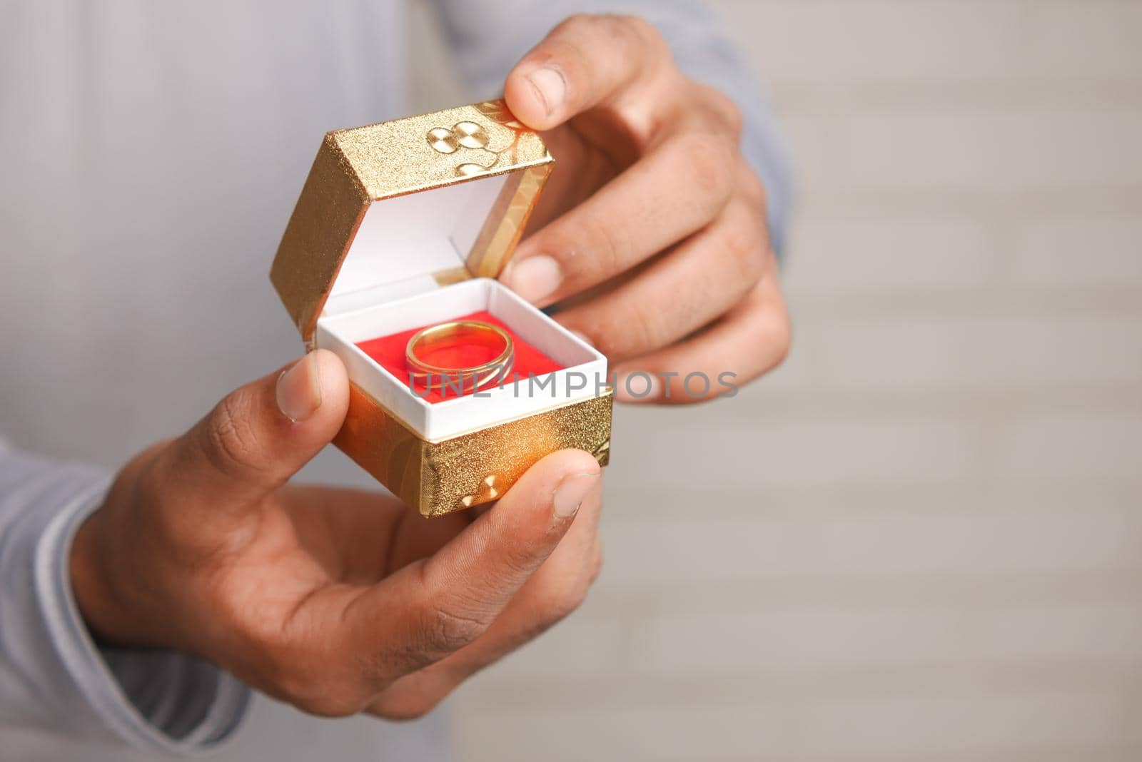 young man hold a wedding ring in a box by towfiq007