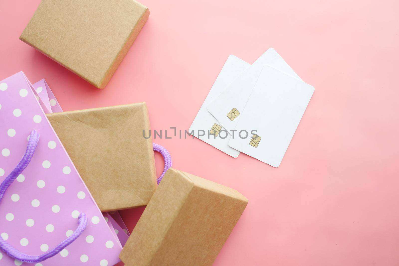 credit cards and gift box on pink background .