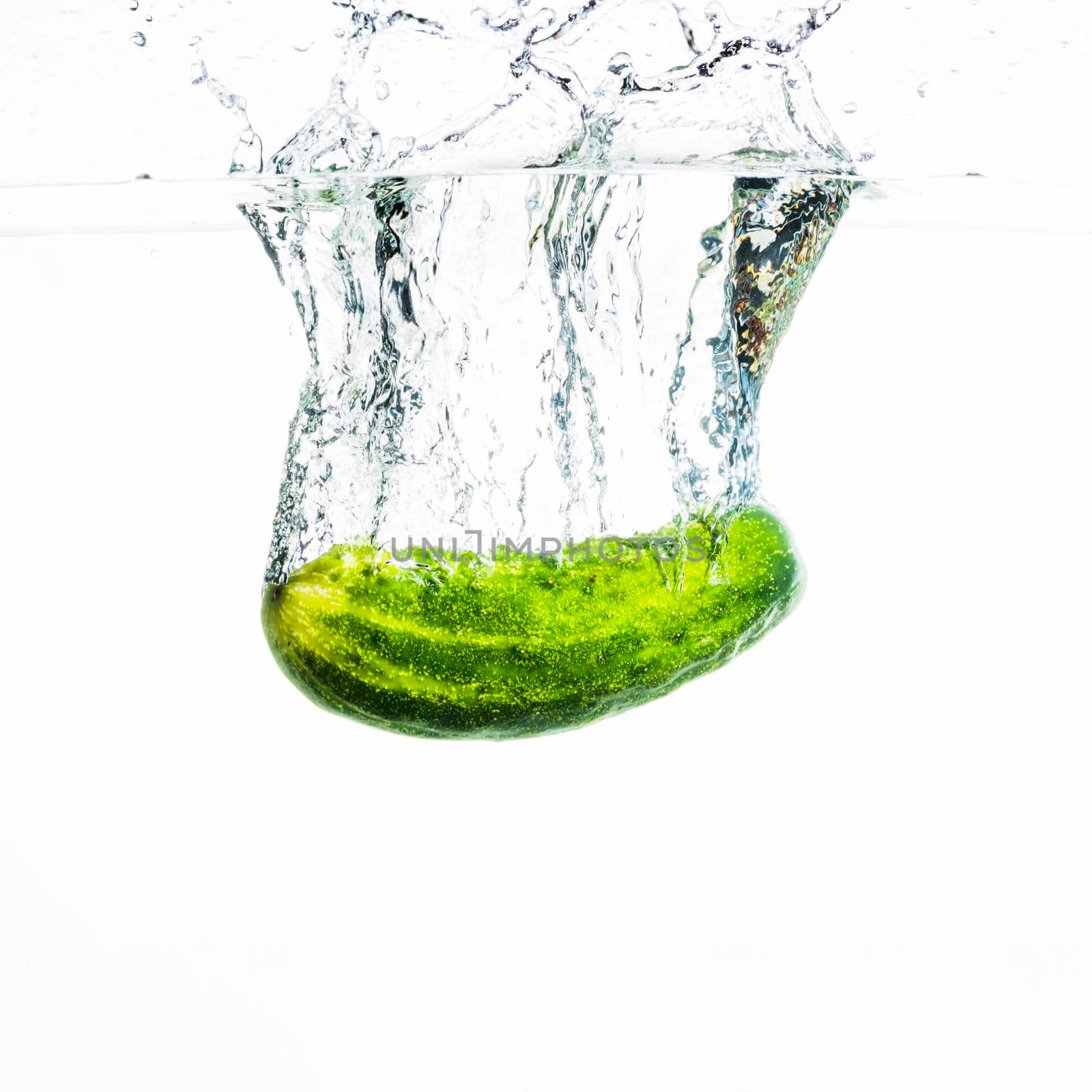 cucumber falling water water splash against white background. High quality photo by Zahard
