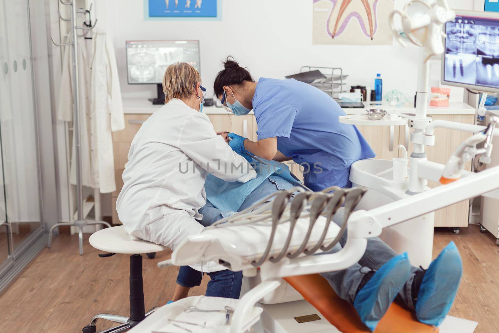 Sick man sitting on dental chair during medical examination by DCStudio