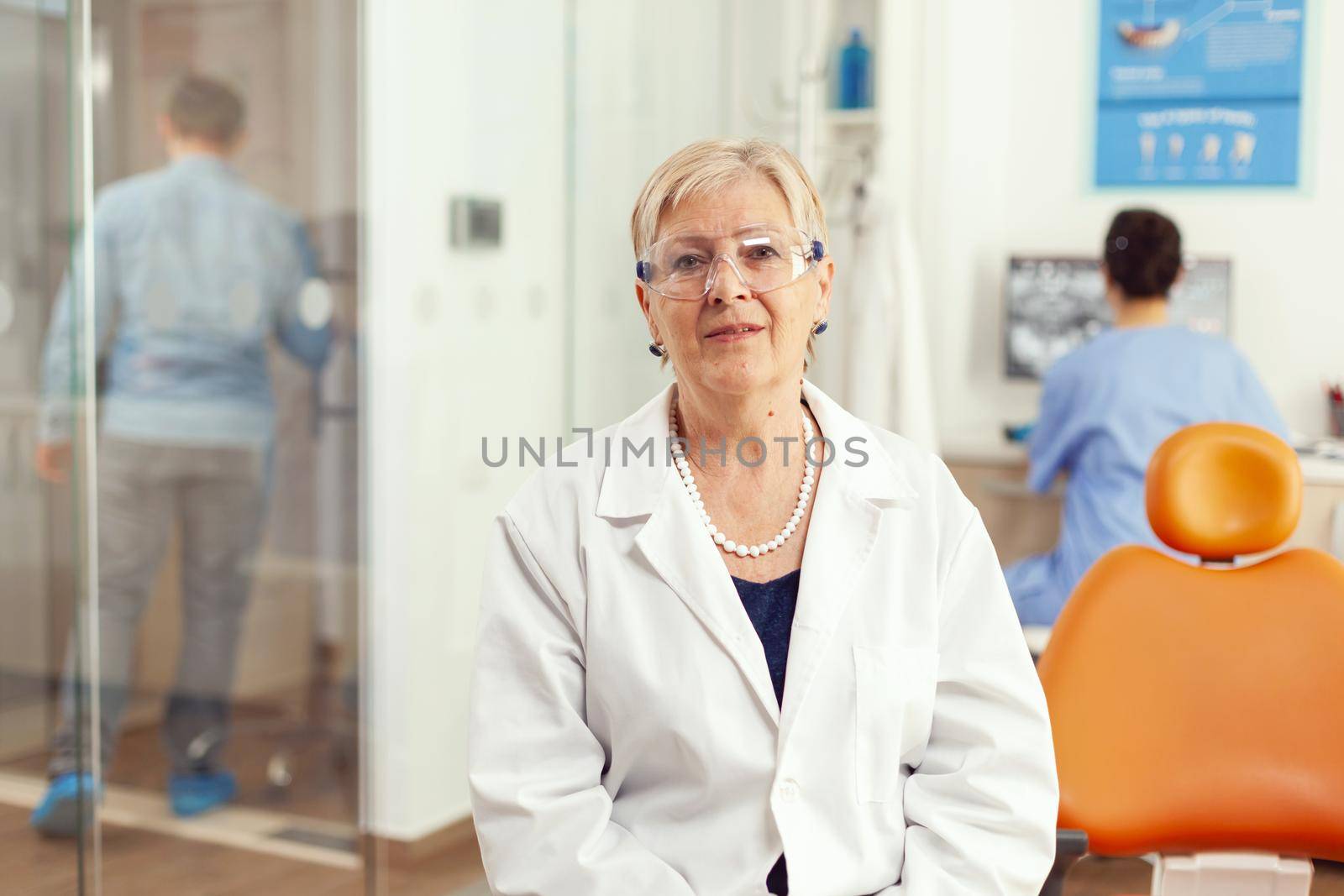 Portrait of specialist senior dentist woman in stomatological office by DCStudio