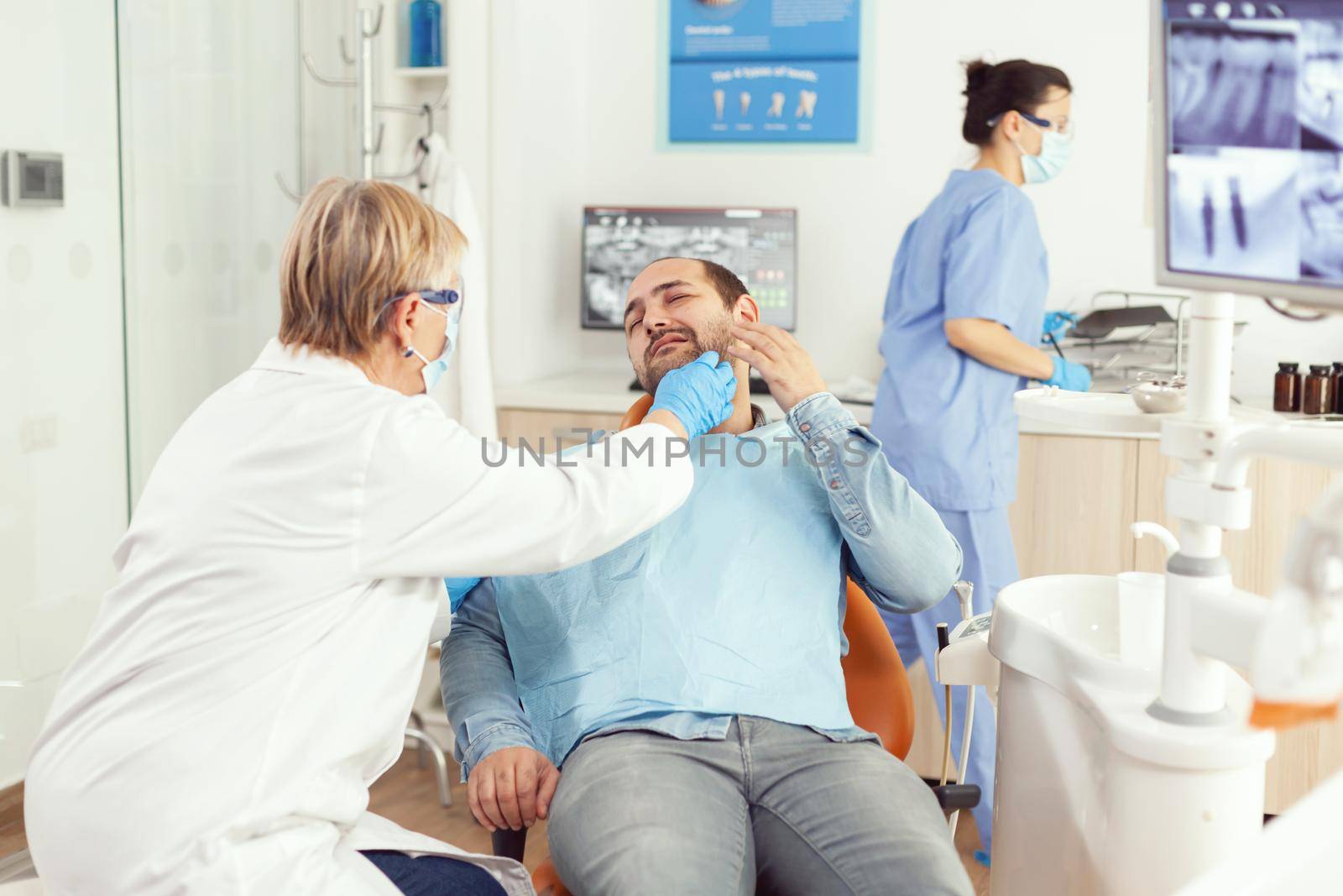 Stomatologist doctor checking patient tooth pain during stomatology appointment by DCStudio