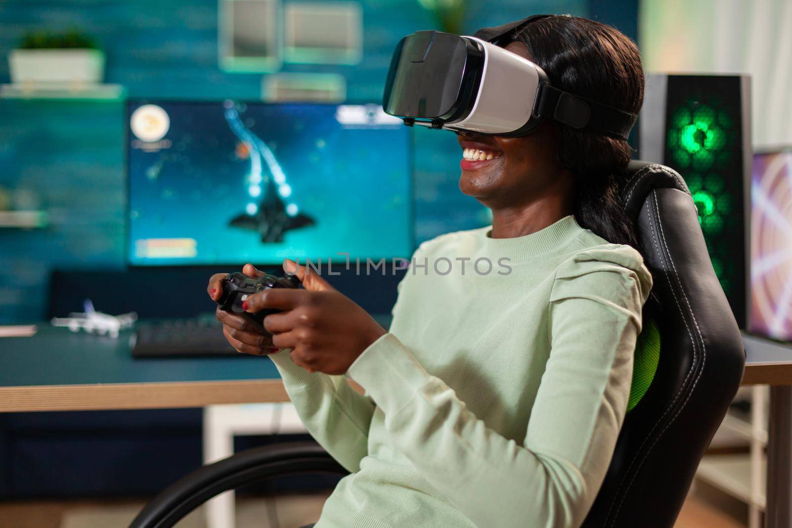 Black woman having fun playing video games with vr headset with controller. Virtual space shooter video game championship in cyberspace, esports player performing on pc during gaming tournament.