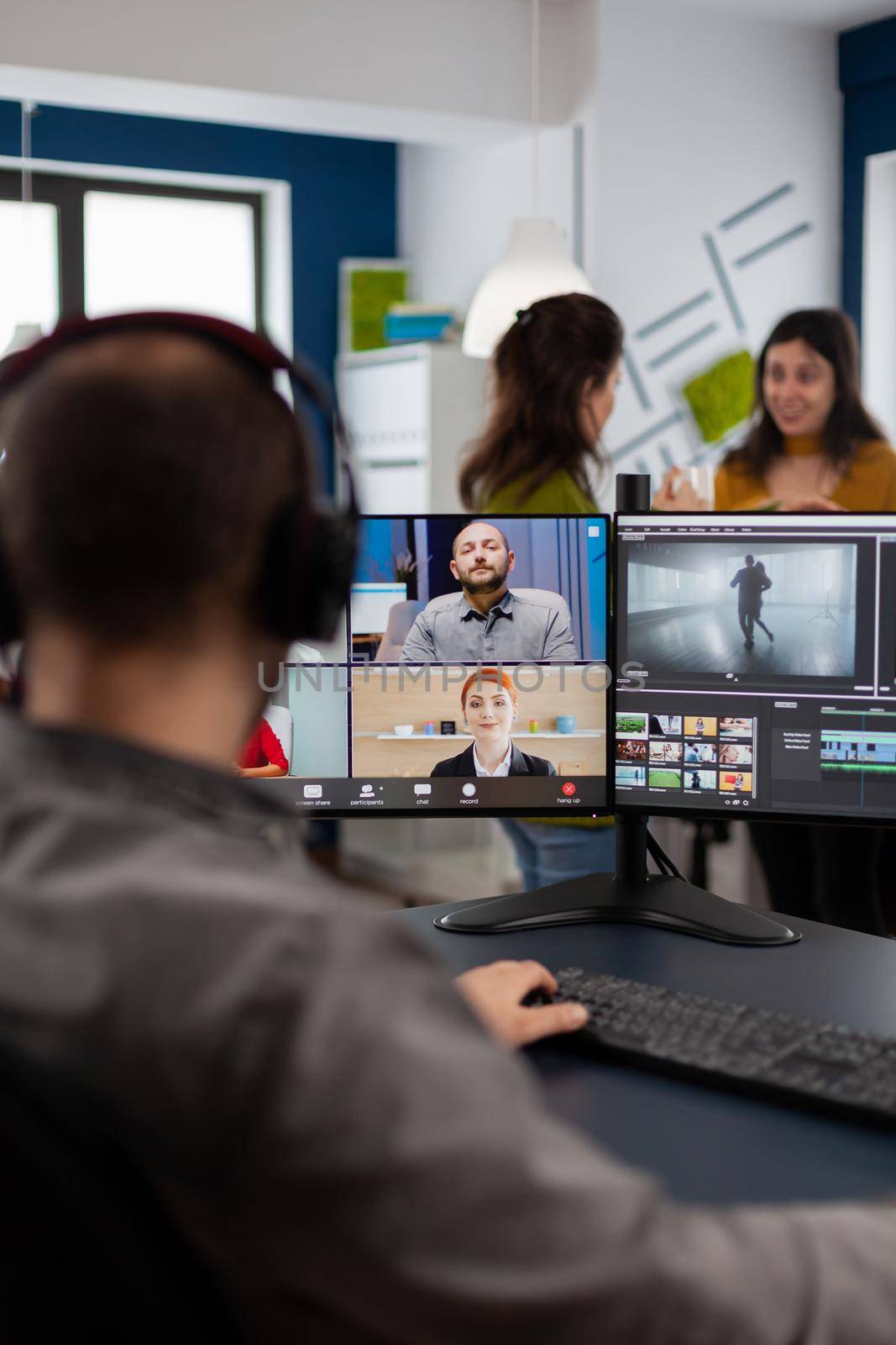 Videographer employee having video conference wearing headset by DCStudio