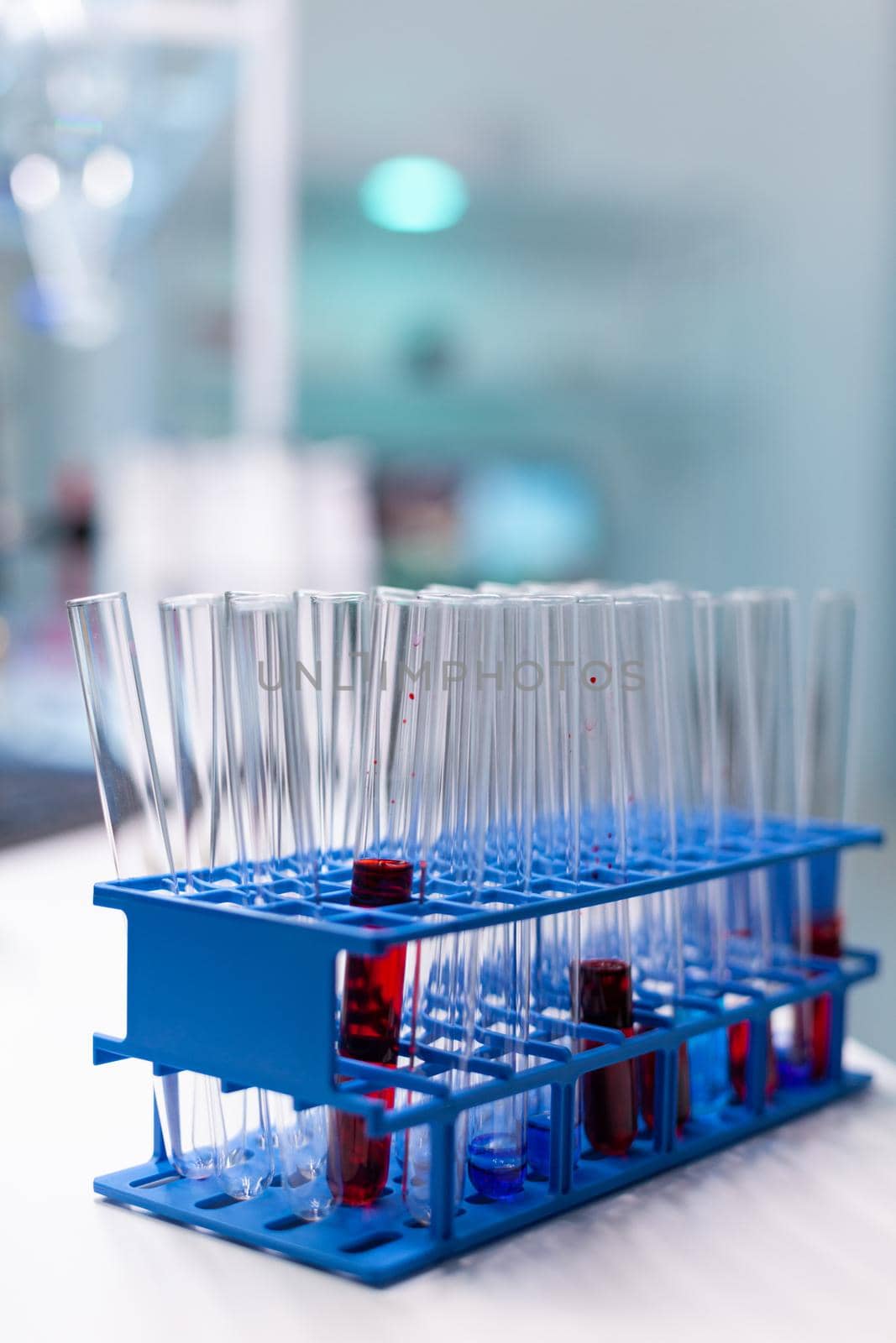 Medical test tube with blood standing on table during chemistry molecular examination in microbiology hospital laboratory. Biochemistry genetics infection. Healthcare treatment