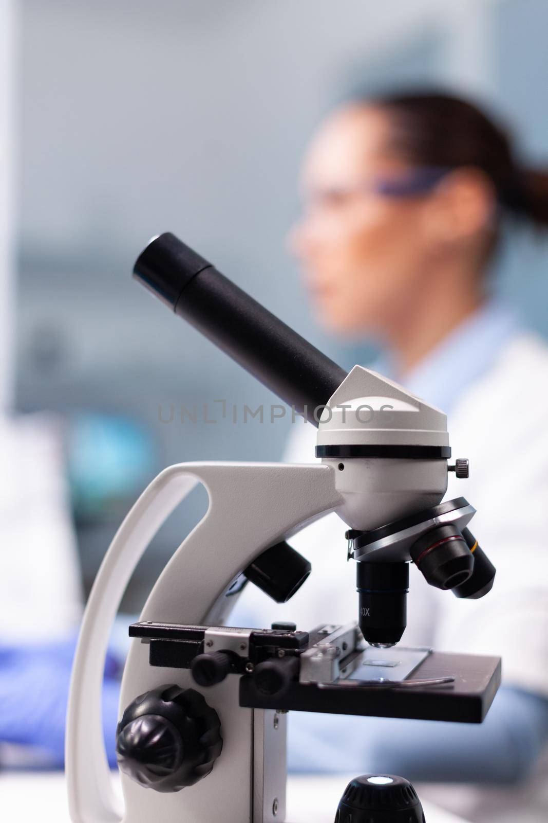 Selective focus on medical microscope standing on table in pharmacology microbiologist hospital laboratory by DCStudio