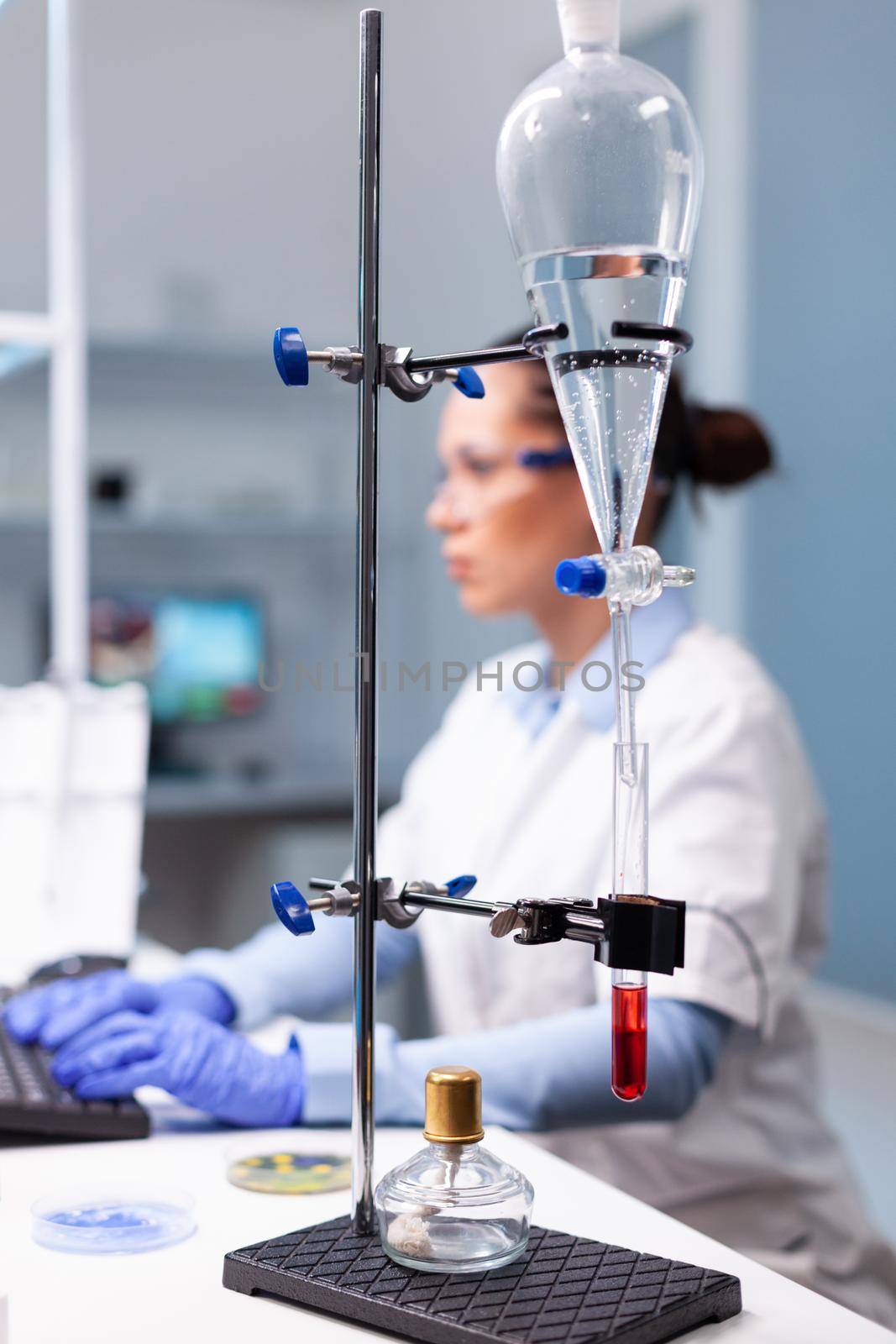 Specialist pharmacist woman typing bacteriology infection test results on computer analyzing pharmaceutical medical expertise in hospital laboratory, Biologist doctor working at medicine experiment