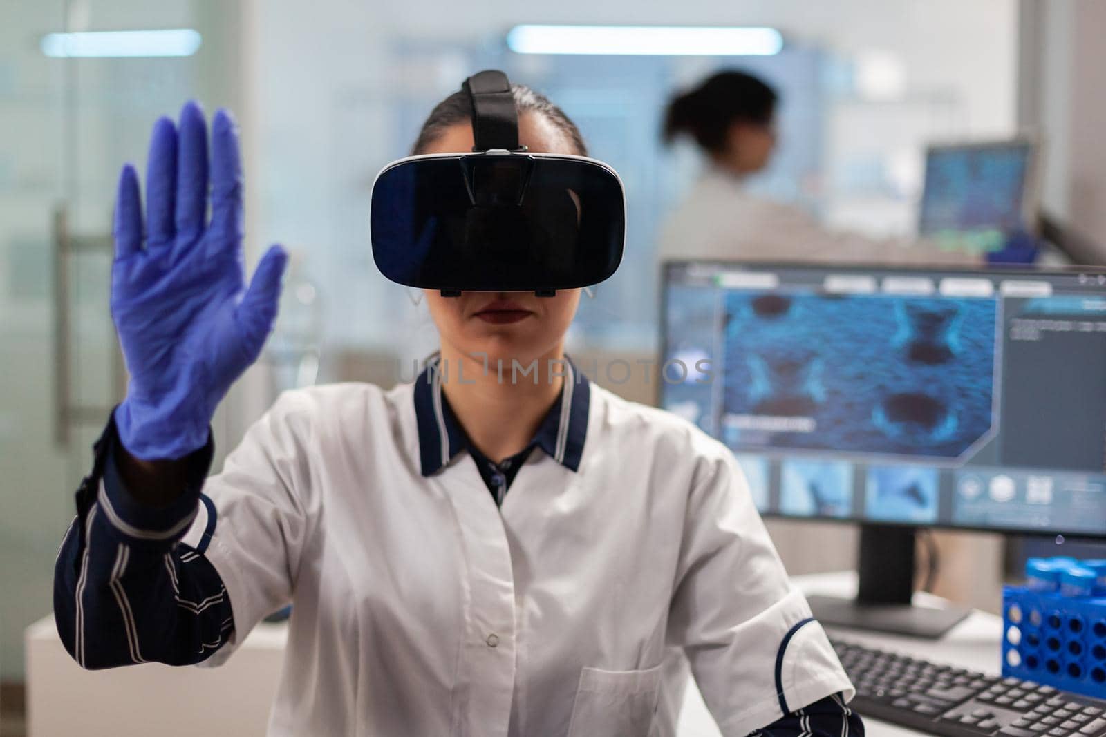 Close up of scientist using vr goggles augmented reality for vaccine development. Team of researchers working with equipment device, future, medicine, healthcare, professional, vision, simulator.
