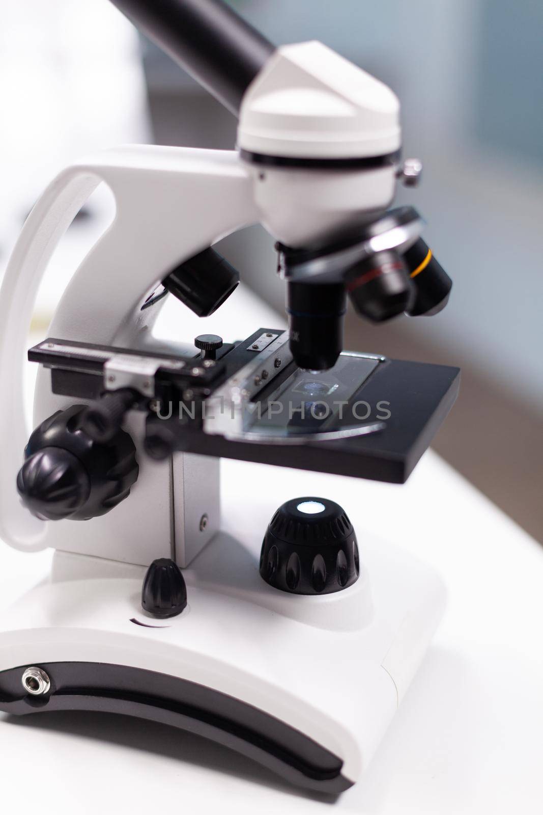 Dna molecular sample under microscope ready for biological virus vaccine investigation in biochemistry pharmaceutical hospital laboratory. Biological expertise research. Healthcare treatment