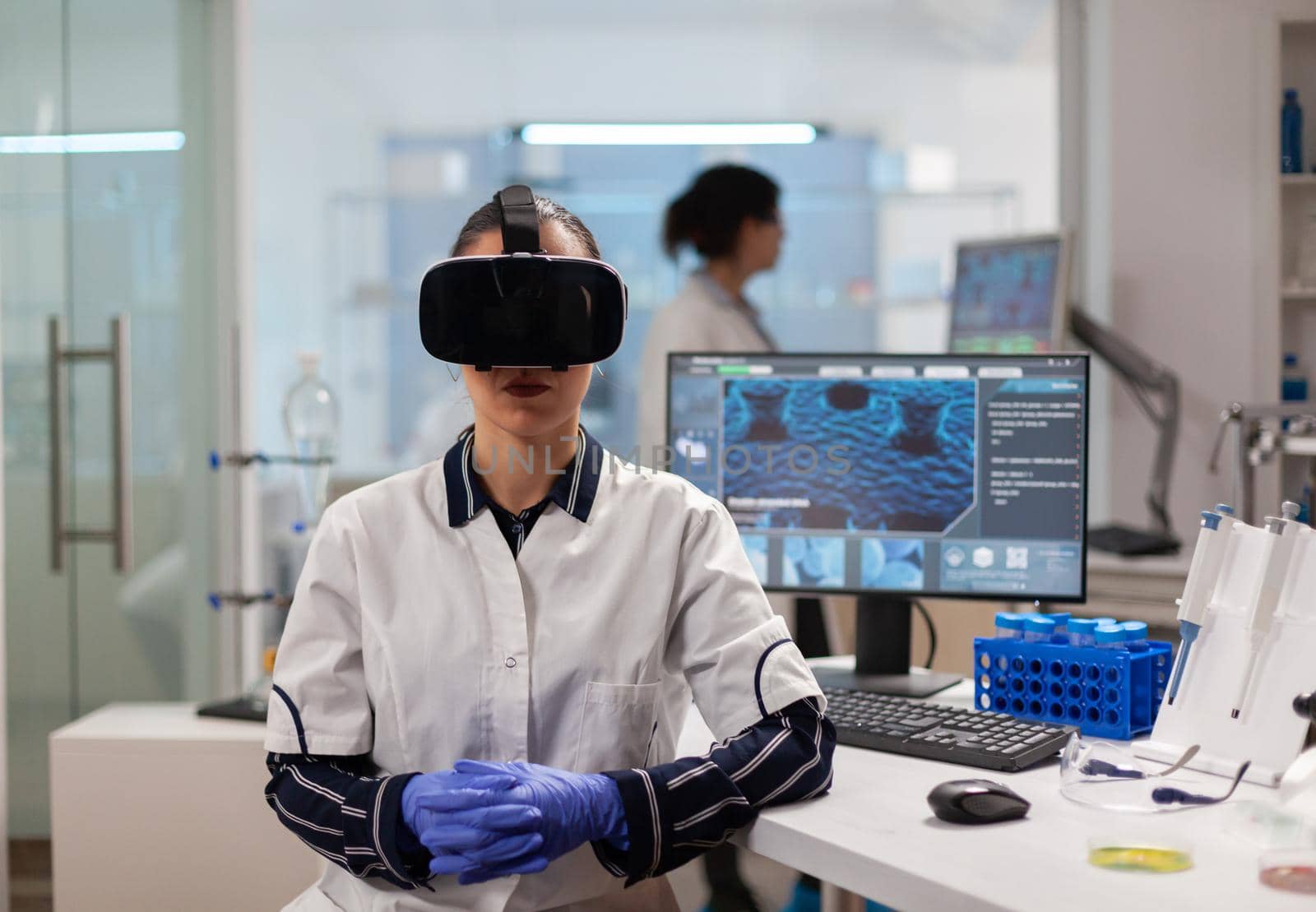 Professional scientist wearing virtual reality glasses using medical inovation in lab. Team of researchers working with equipment device, future, medicine, healthcare, professional, vision, simulator.