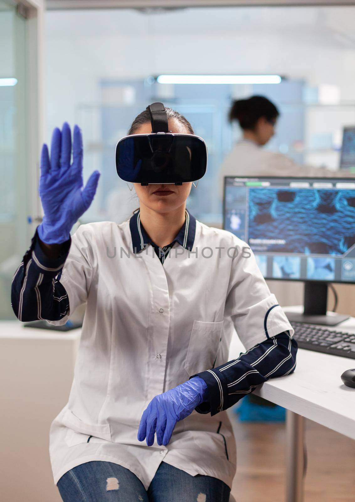 Laboratory doctor experiencing virtual reality using vr goggles in medical research lab. Team of researchers working with equipment device, future, medicine, healthcare, professional, vision, simulator.