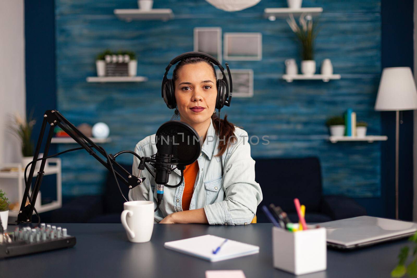 Famous video blogger streaming from home studio podcast using professional recording equipment. Social Media content creator making fashion content for her channel where is sharing advice for beauty community