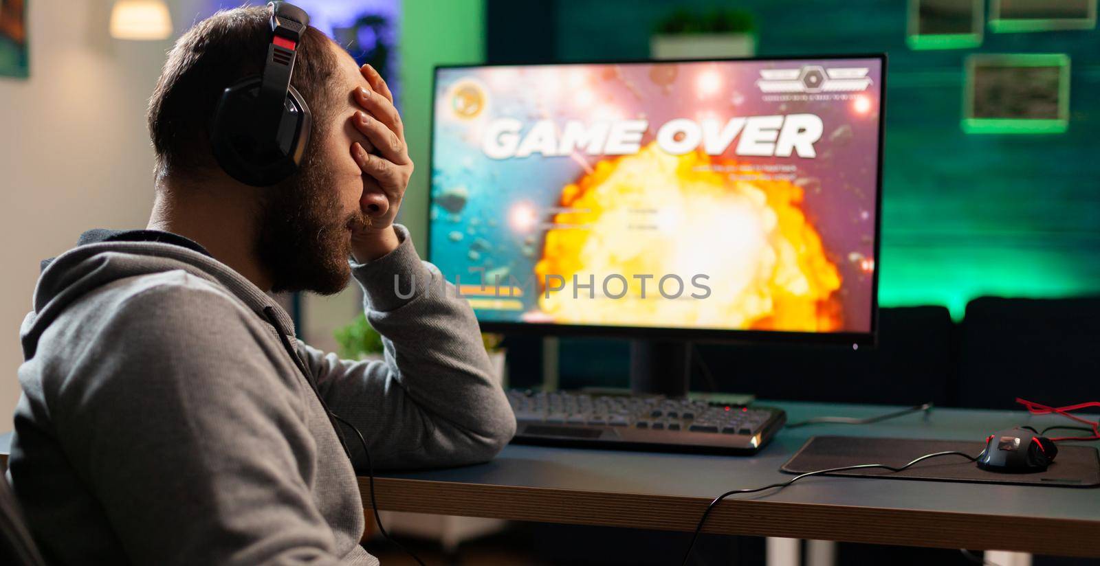 Gamer with headset and microphone losing video games by DCStudio