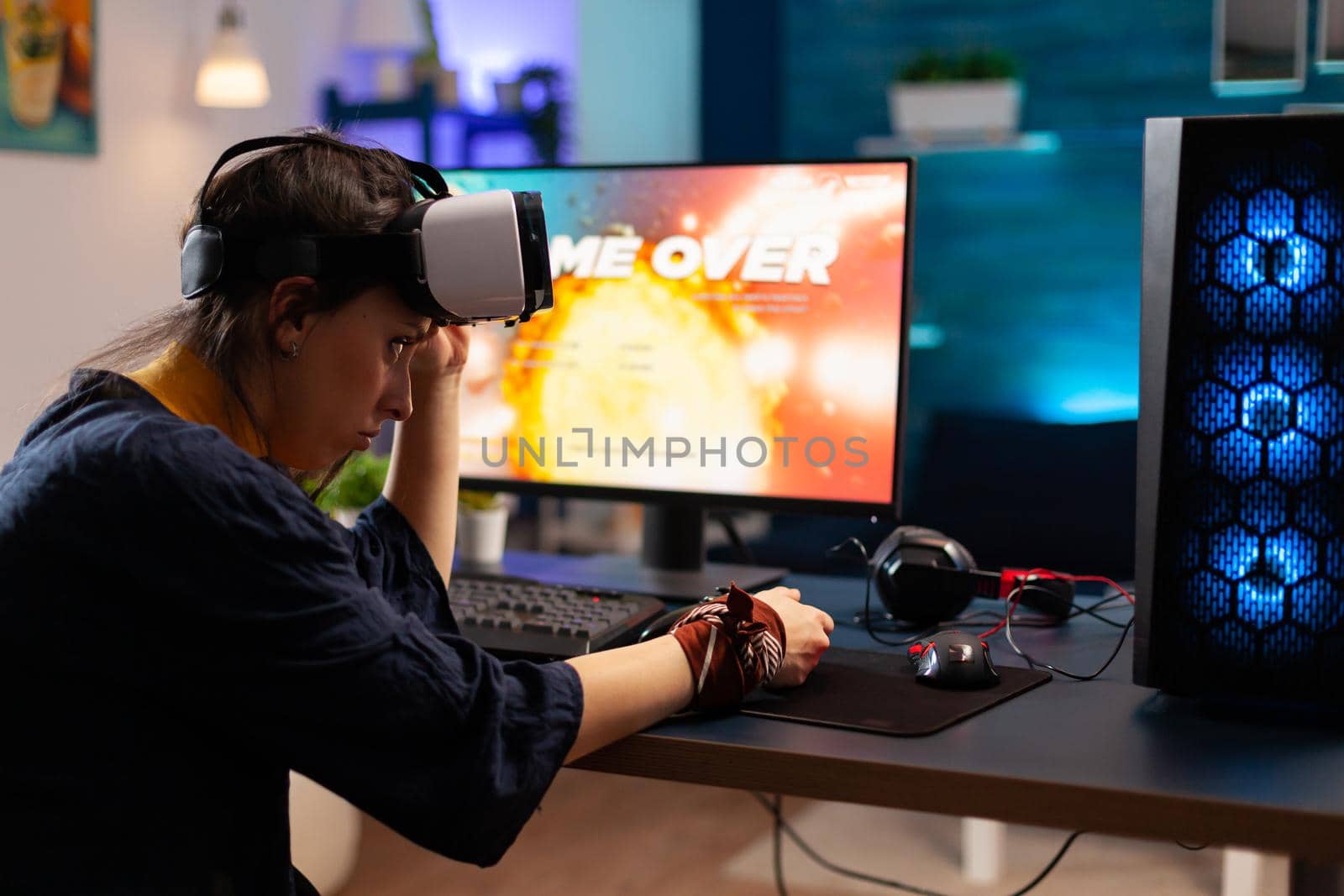 Player man taking off his virtual reality goggles after losing at online videogames. Defeated gamer using professional controller for championship sitting on gaming chair late at night in living room