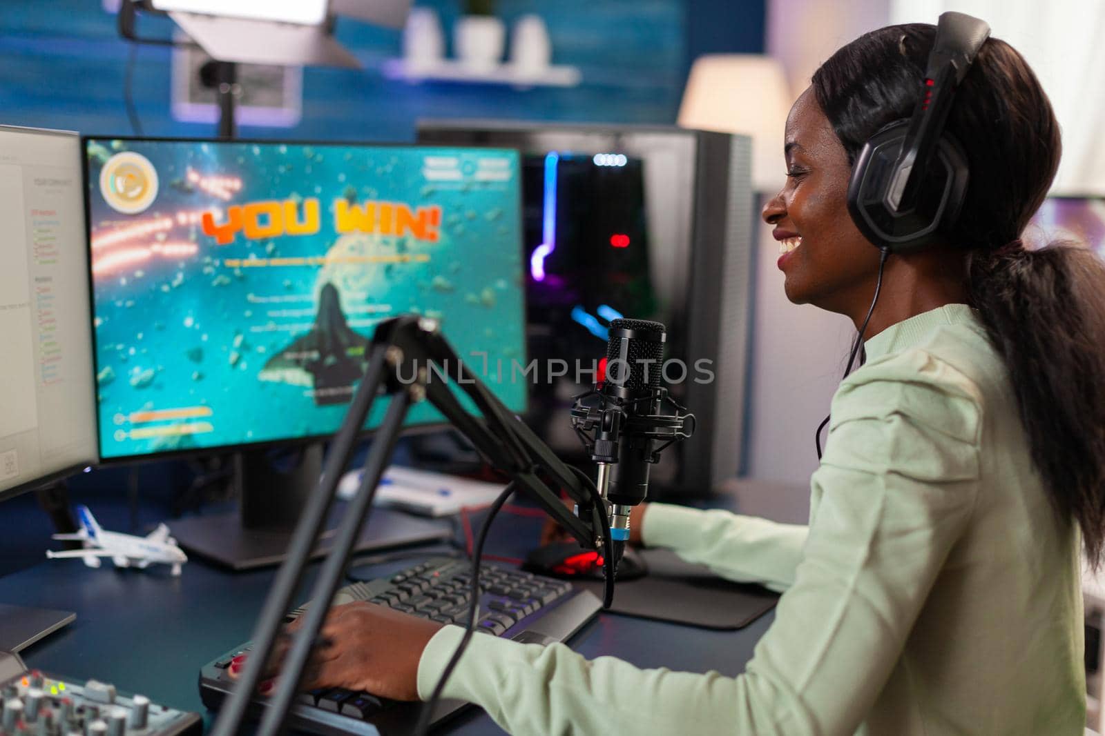 Excited professional african e sports player during stream of competition by DCStudio