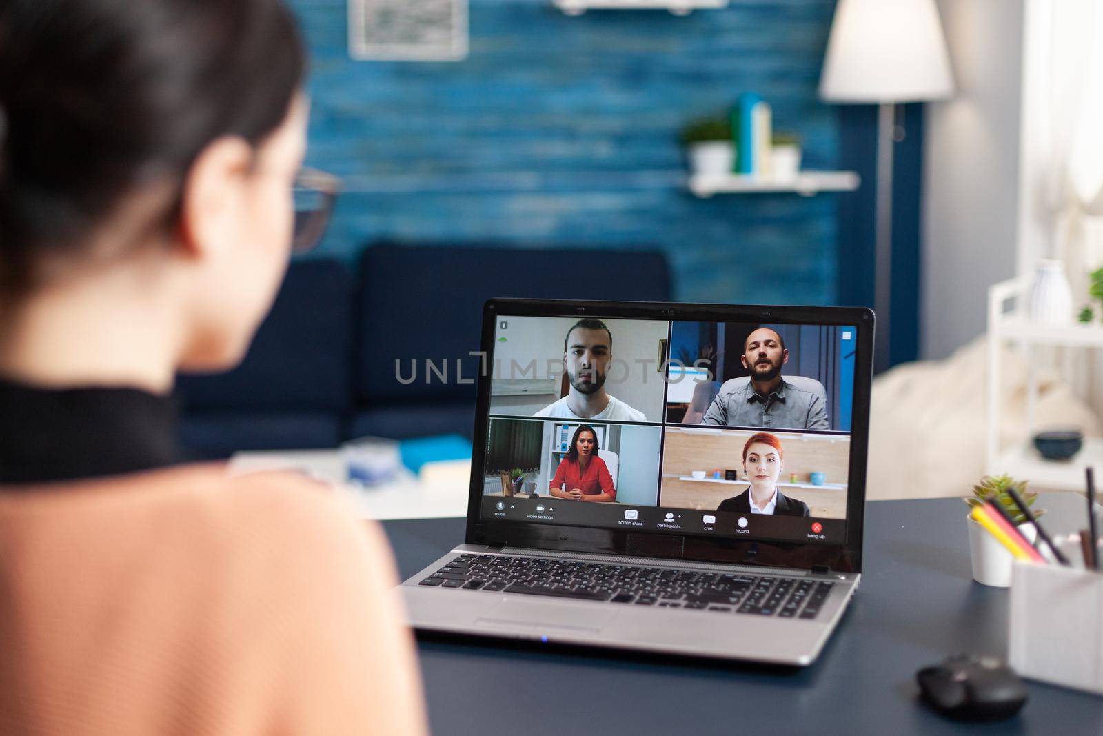 Student listening colleagues during online videocall school by DCStudio