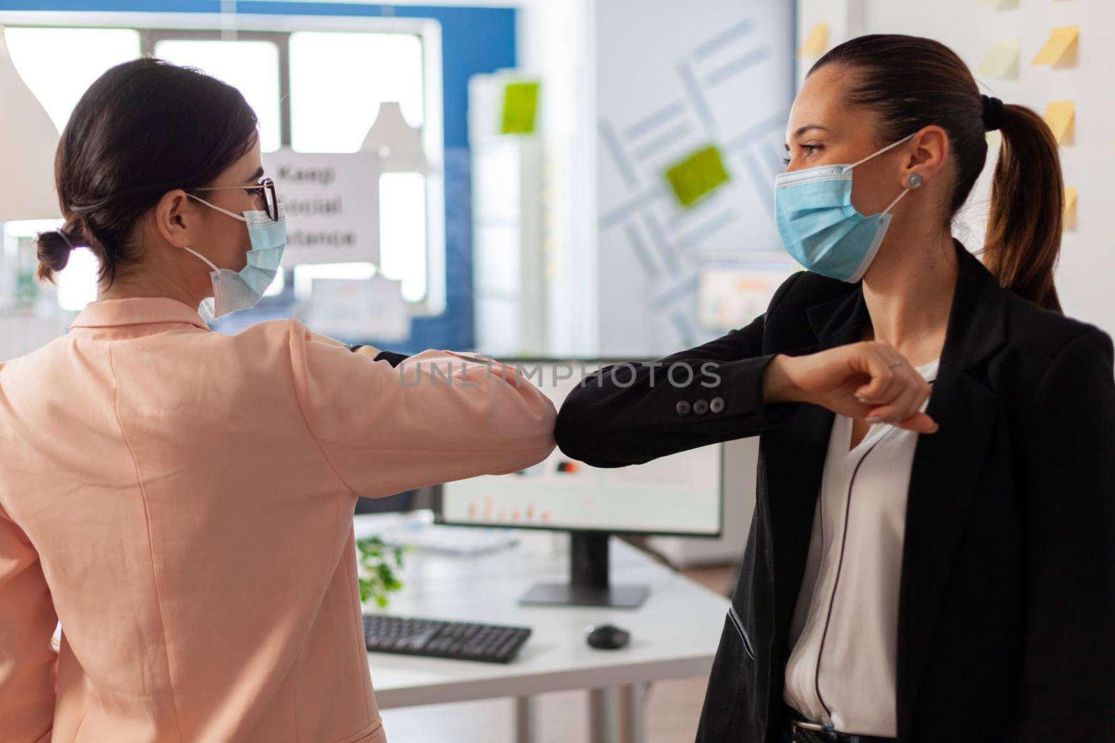 Woman in business office following safety precaution by DCStudio