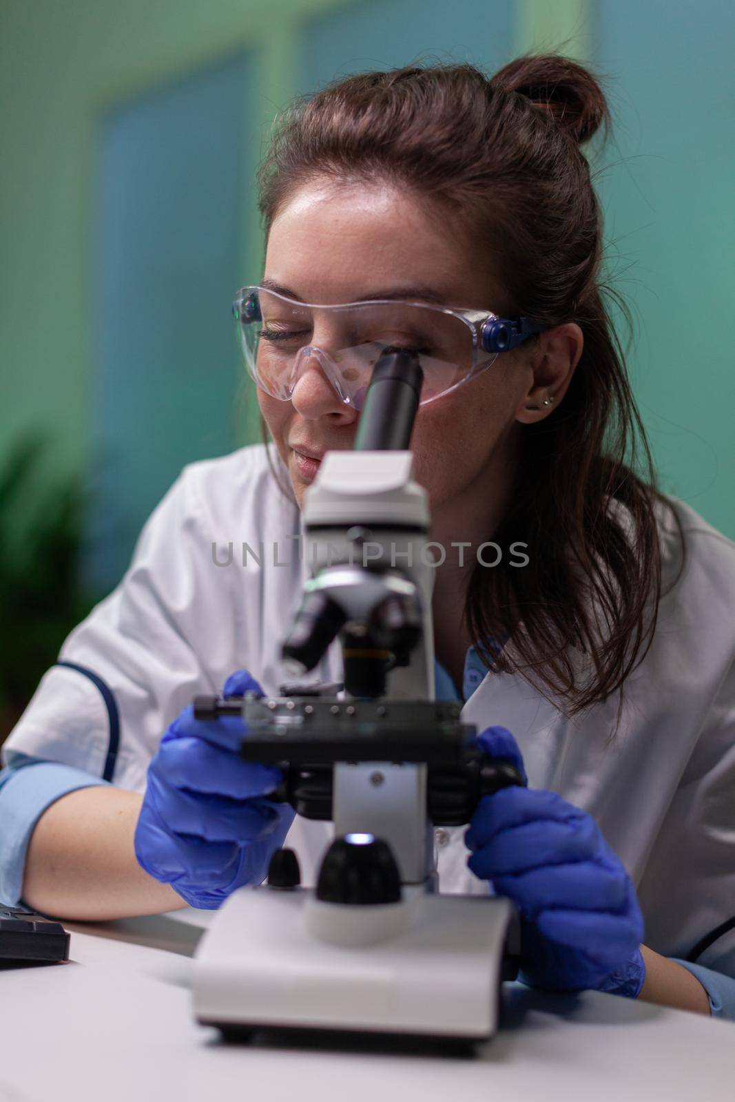 Biochemistry doctor examining chemical test using microscope for genetic researcher. Biologist specialist discovery organic gmo plants while working in microbiology food laboratory.