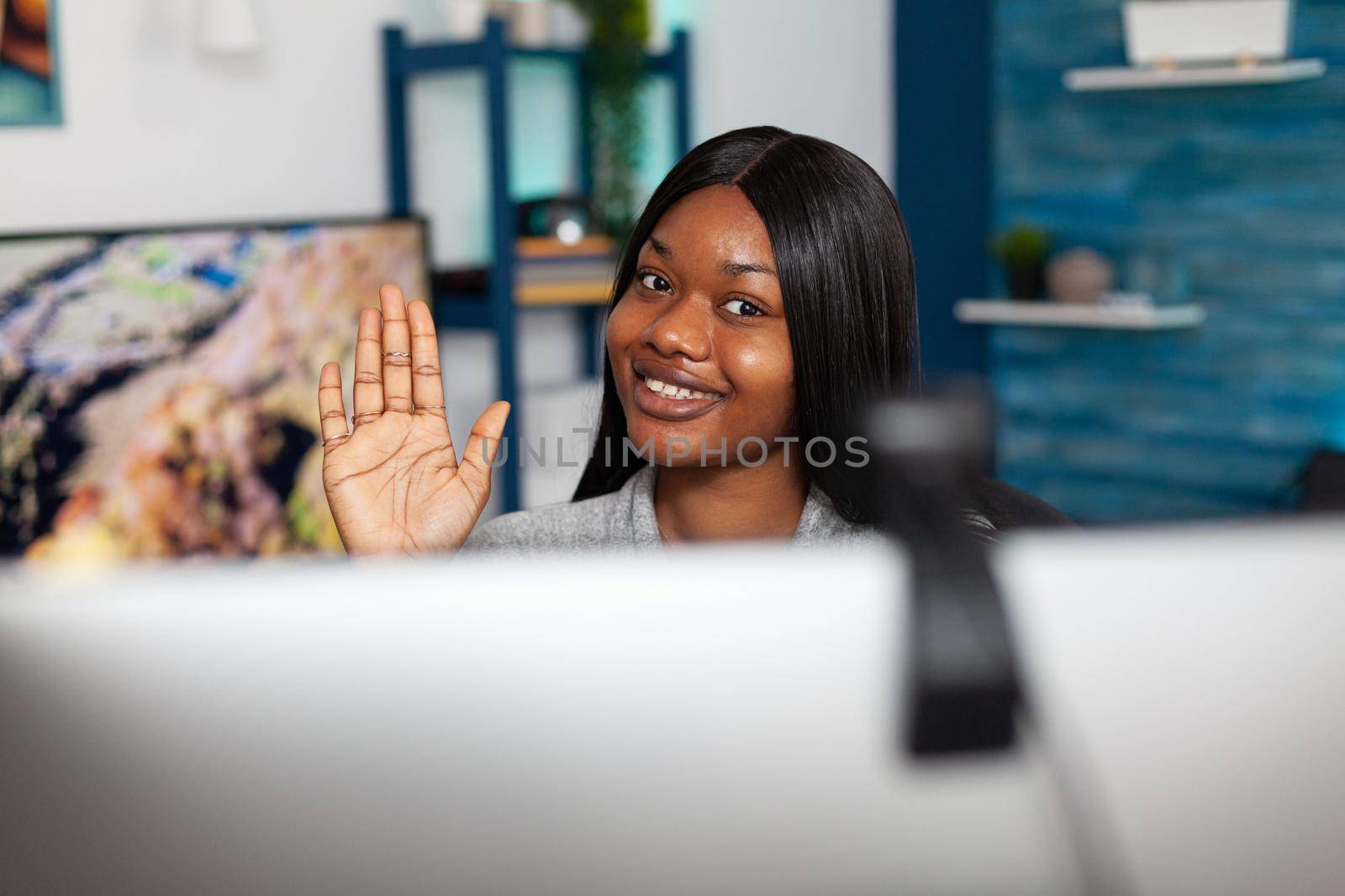 Black student greeting high school teacher talking maths lesson course during online videocall meeting conference working remote from home. Selective focuse on computer webcam