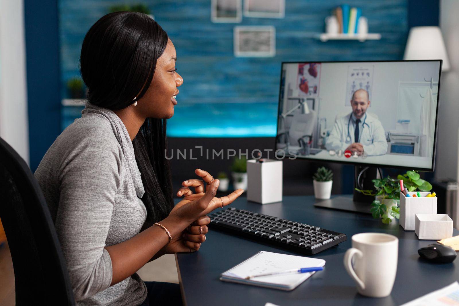 African patient talking with therapist doctor explaining disease test results discussing pills treatment during online telemedicine videocall conference meeting. Student having respiratory illness