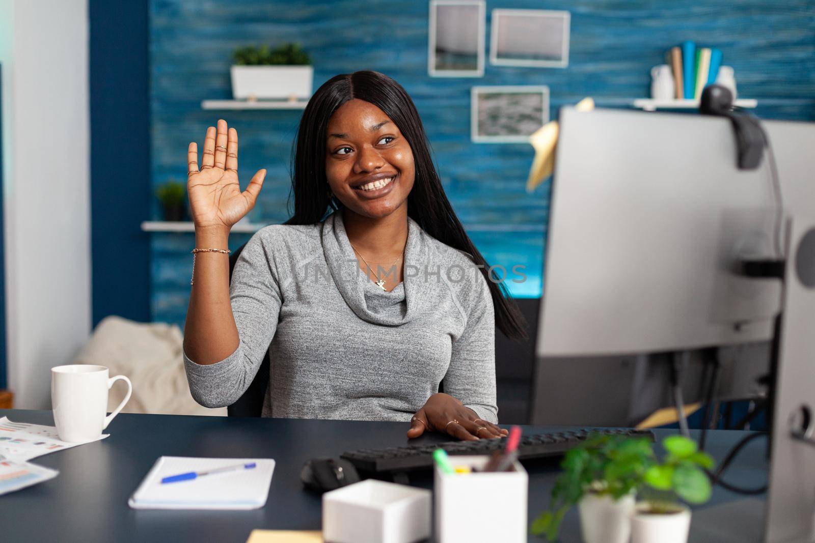 Student with dark skin waving university teacher during online videocall meeting conference listening education webinar. African american woman working remote from home using high school platform