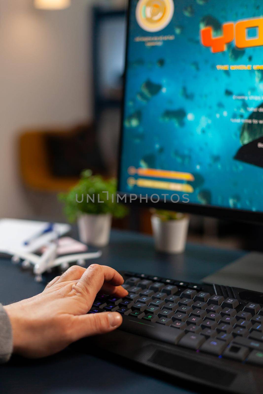 Close up hand of pro gamer during online tournament using RGB keyword by DCStudio