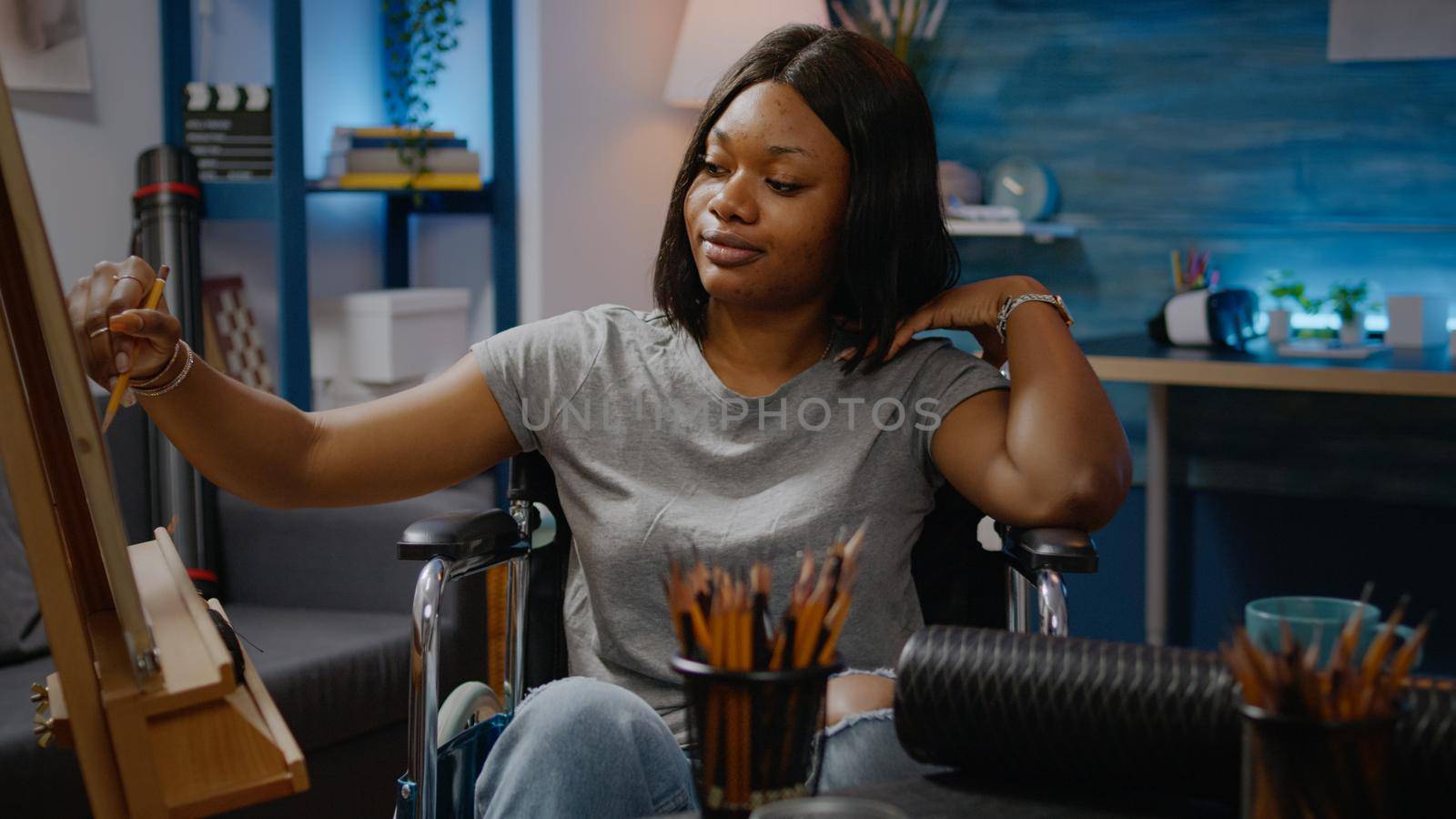 Disabled black woman drawing vase design at art studio by DCStudio