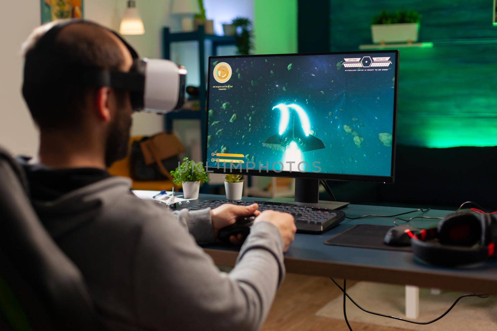 Caucasian gamer playing space shooter championship while wearing virtual reality headset. Defeated gamer using professional console for online tournament late at night in gaming room
