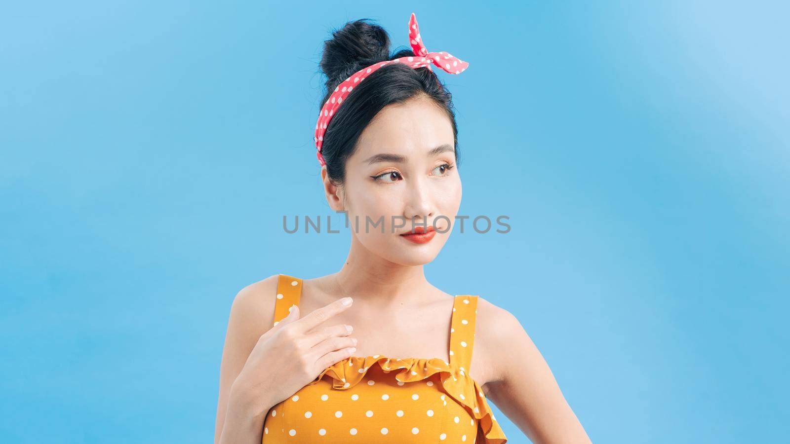 Beautiful girl in a romantic dress smiling pretty on a blue background. by makidotvn