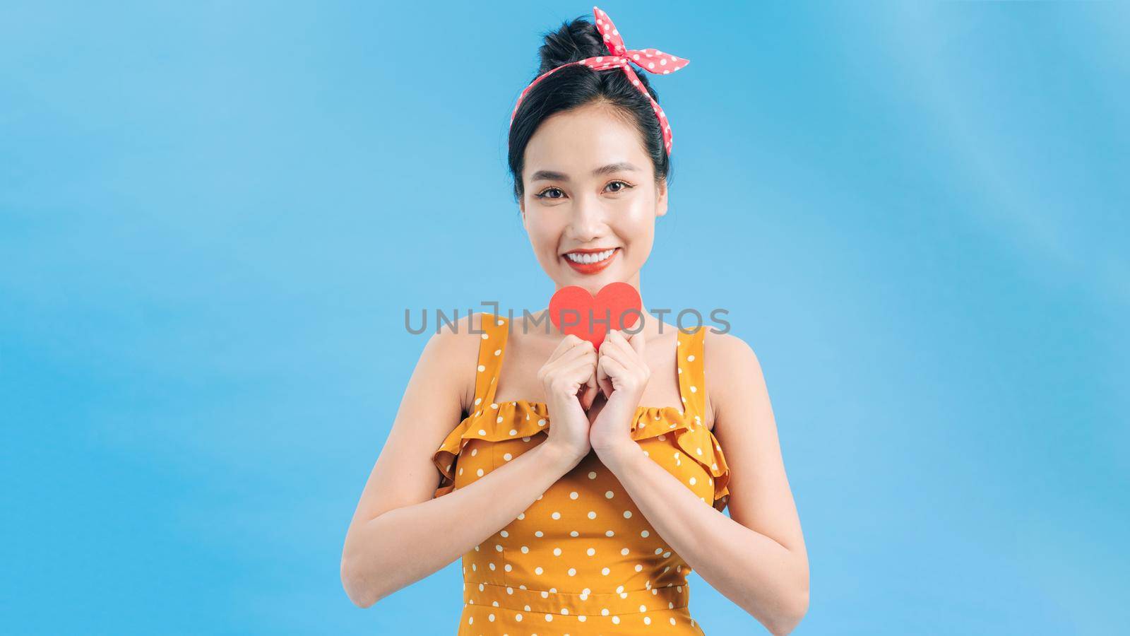 young smile woman hold red heart. valentine day concept. healthy lifestyle by makidotvn