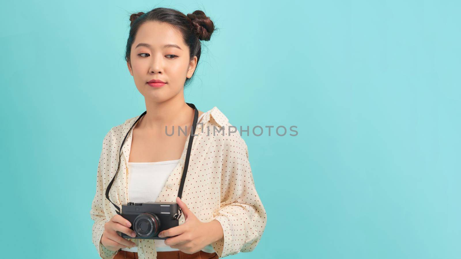 Happy woman tourist travel holding camera isolated on white background, asian