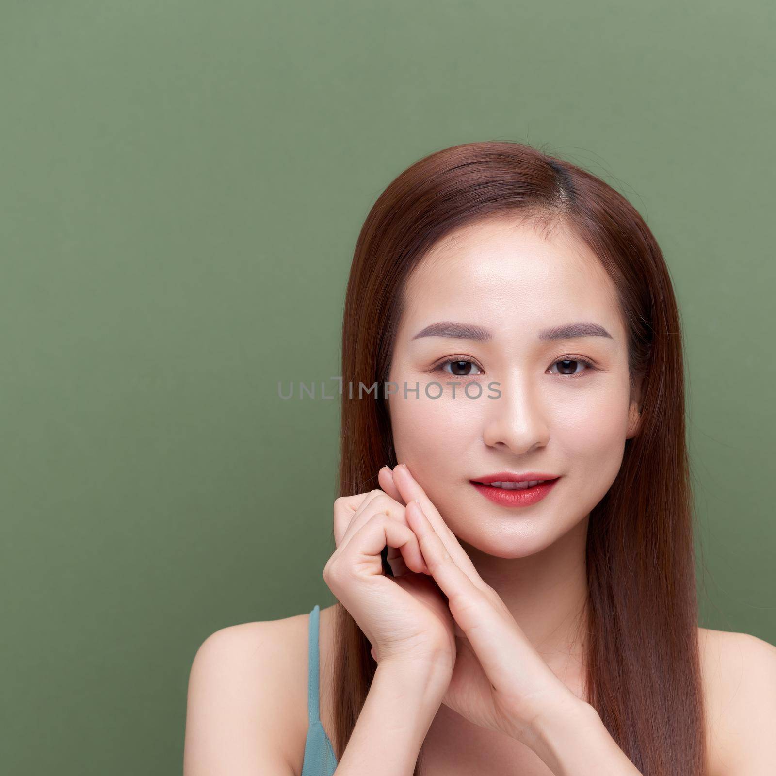 Beautiful young woman with silky skin after spa treatment on color background by makidotvn