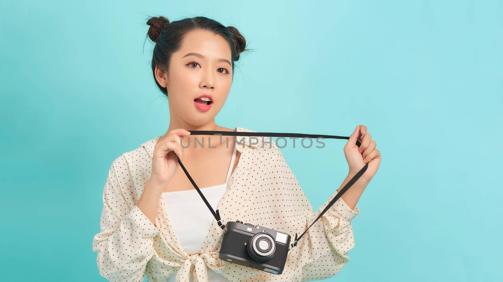 Happy woman tourist travel holding camera isolated on white background, asian