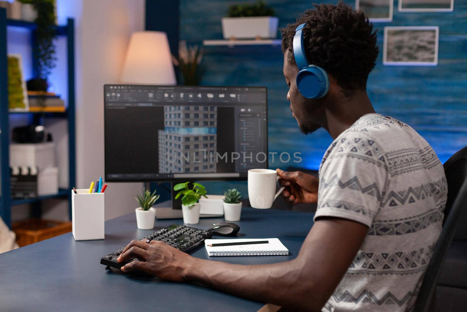 African american architect holding cup of coffee analyzing building construction plan by DCStudio