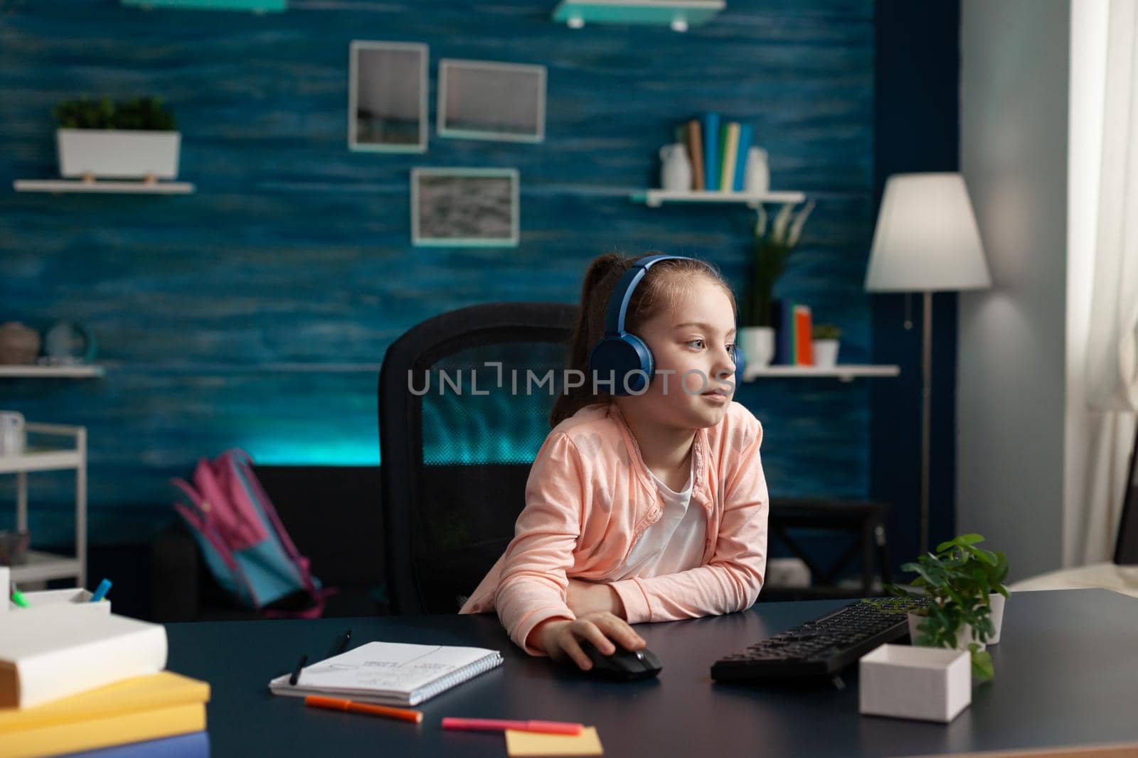 Modern school pupil paying attention to online class by DCStudio