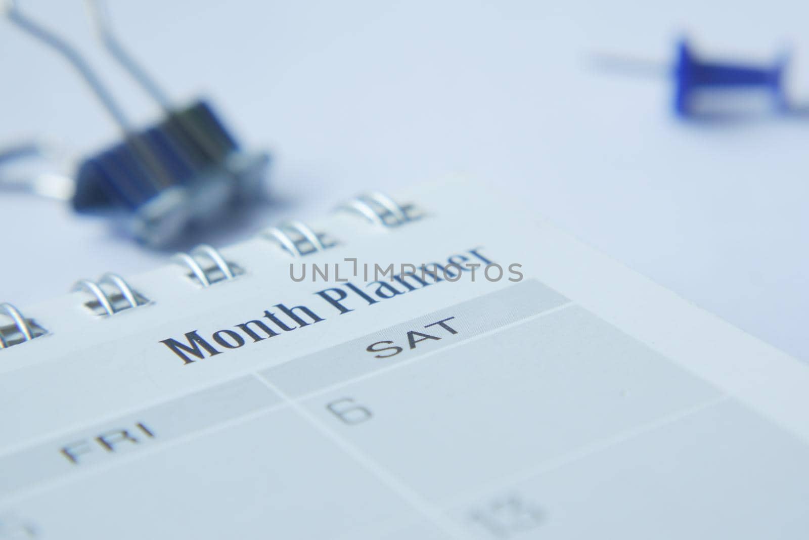 close up of monthly planner and notepad on table .