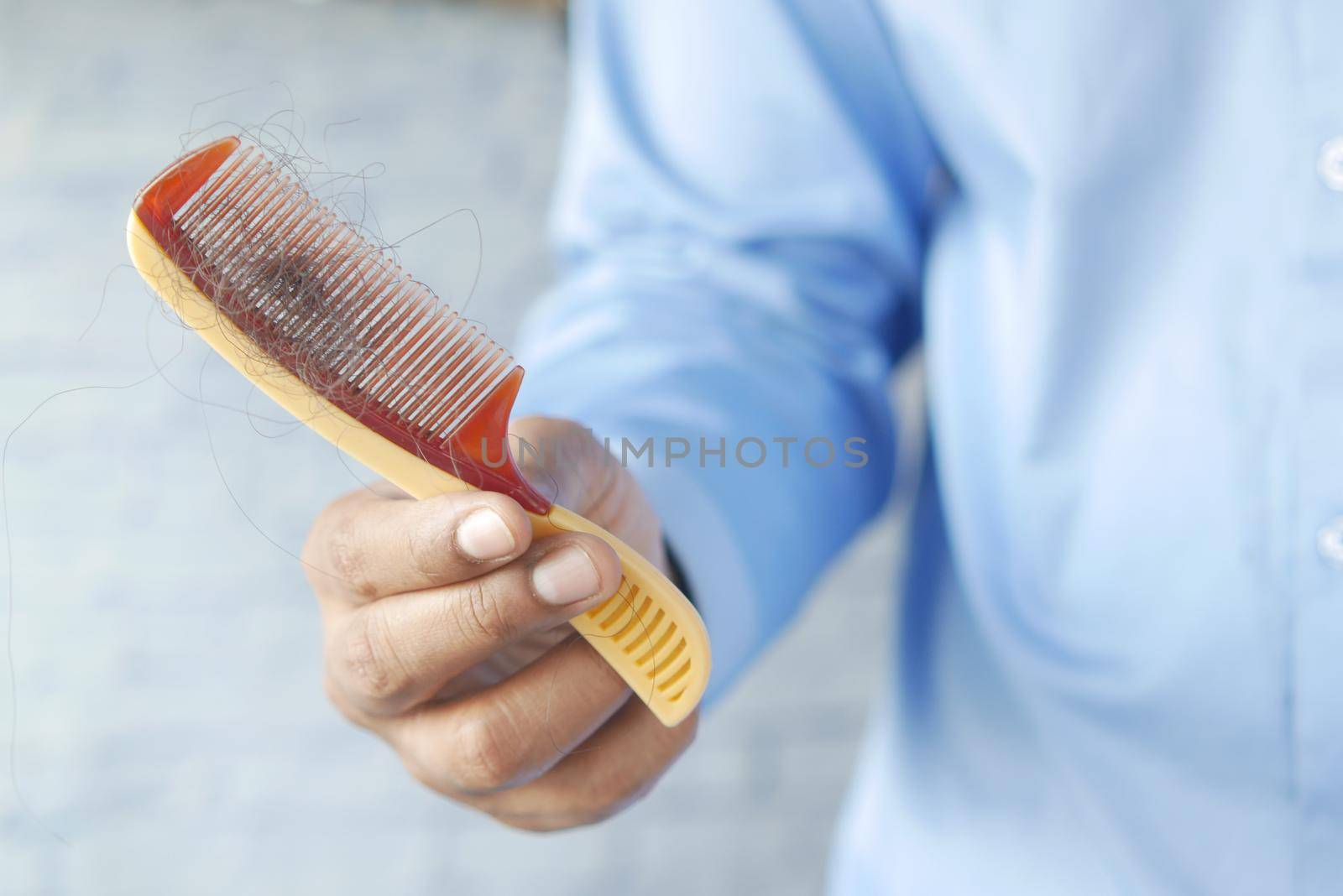 man hold his list hair close up ,