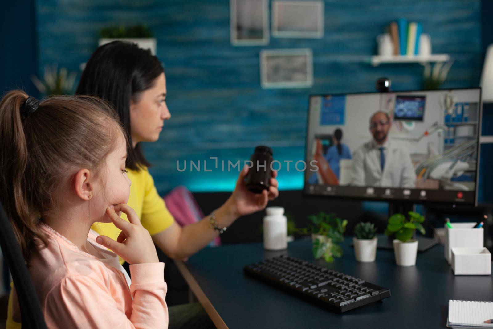 Concerned mother talking to doctor on video call conference technology about child healthcare problems. Caucasian adult using telemedicine for healing treatment diagnosis and pills
