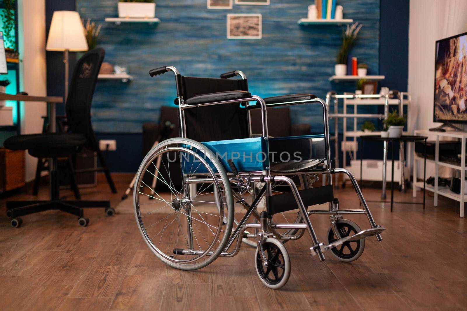 Close up of empty wheelchair for disability at home. Modern medical equipment for people transportation support indoors. Nobody in living room but recovery and mobility healthcare help