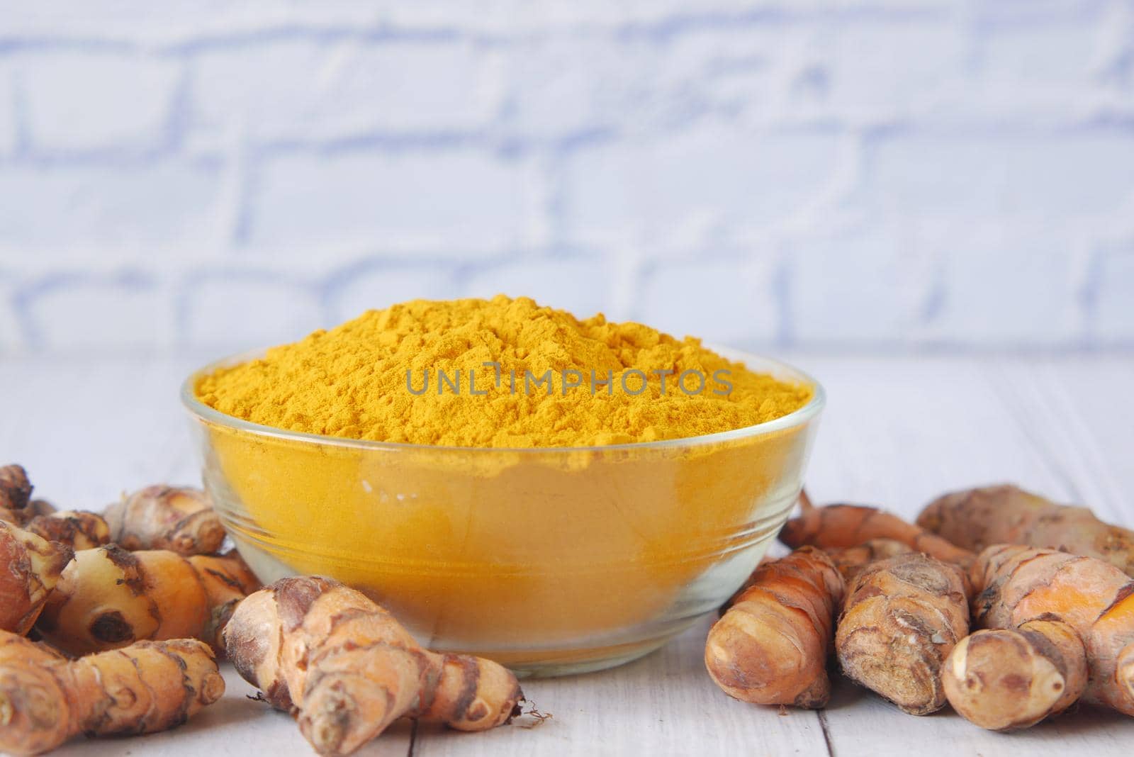 detail shot of turmeric root in bowl on table